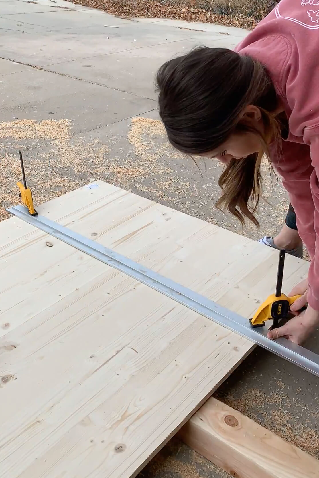 Using a circular saw to cut off the end of a DIY table.